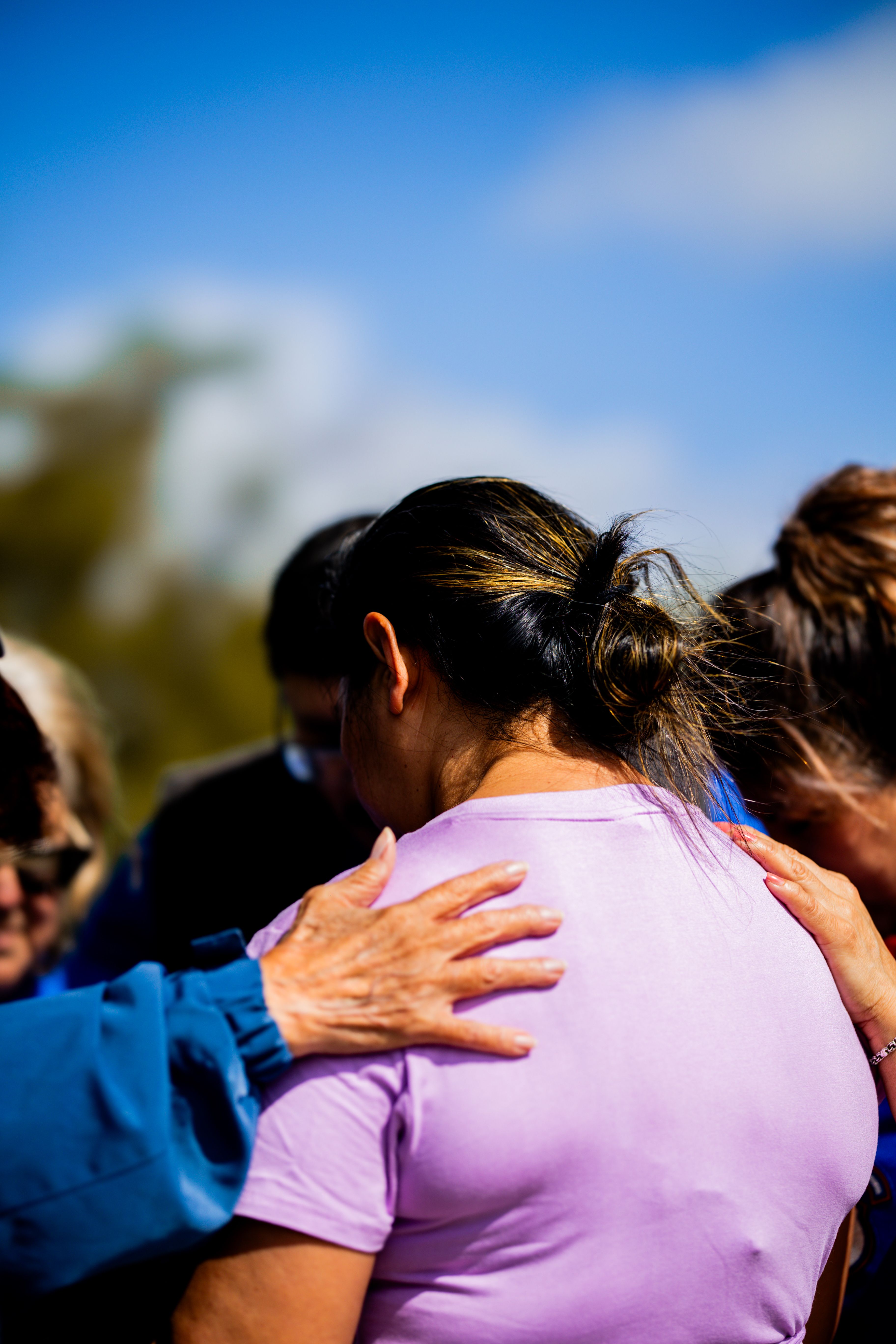 Women gathered together in an embrace